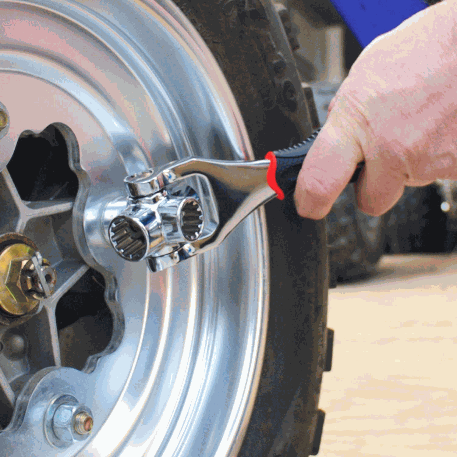 48 in 1 Tools universal wrench in use on a wheel bolt for easy repair.
