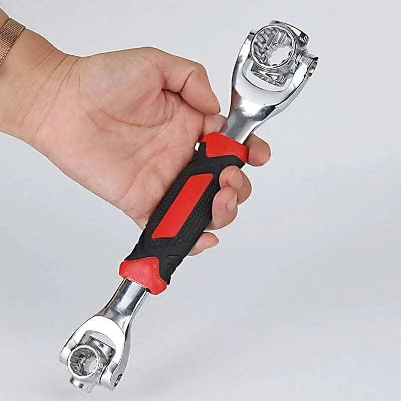 Universal wrench in hand showcasing red and black grip design.