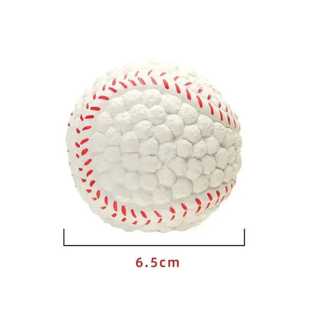 White squeaky dog toy ball with red stitching, 6.5 cm in diameter.