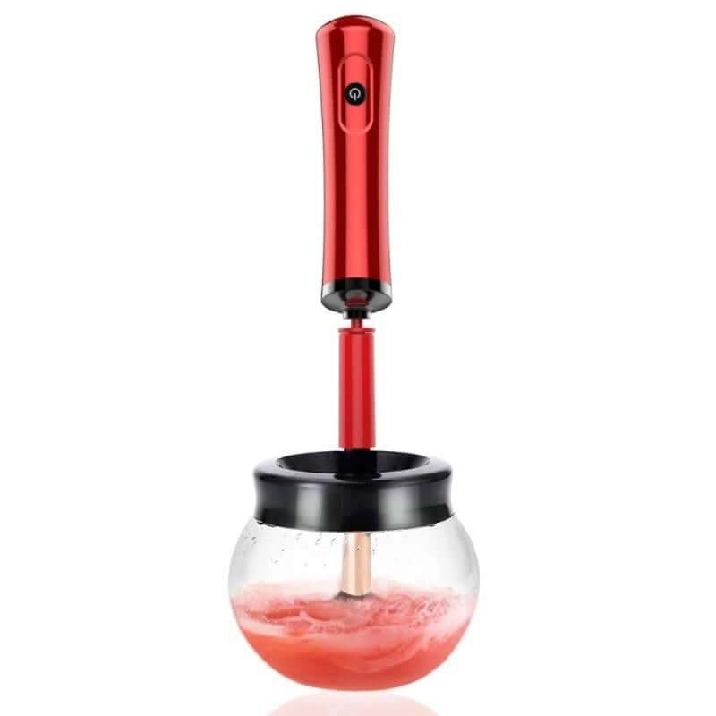 Electric makeup brush cleaning device in red with ergonomic handle and transparent bowl.