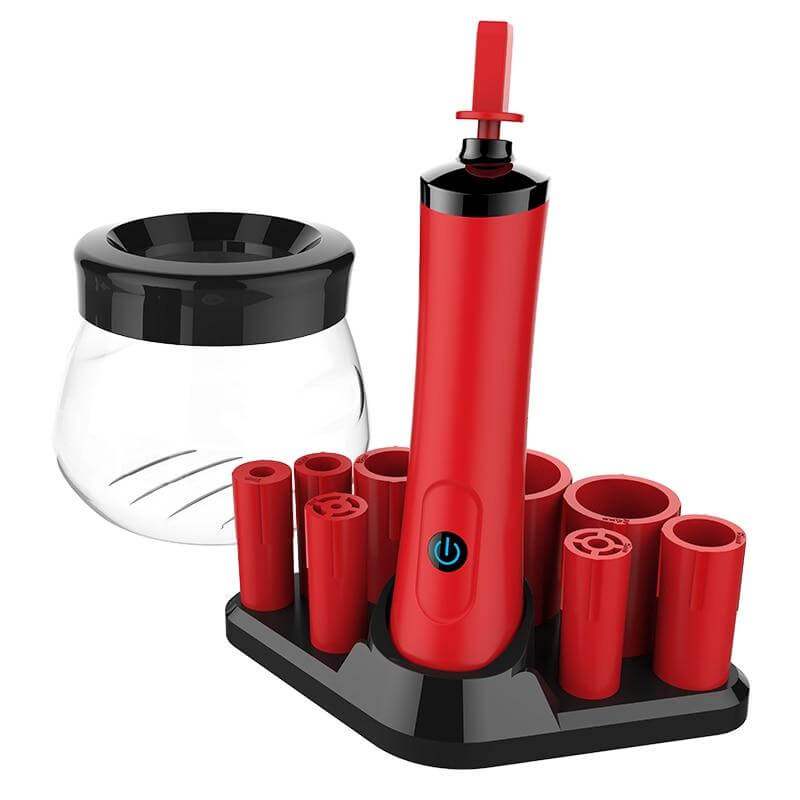 Electric makeup brush cleaning device in red and black with a clear bowl and multiple silicone collars.