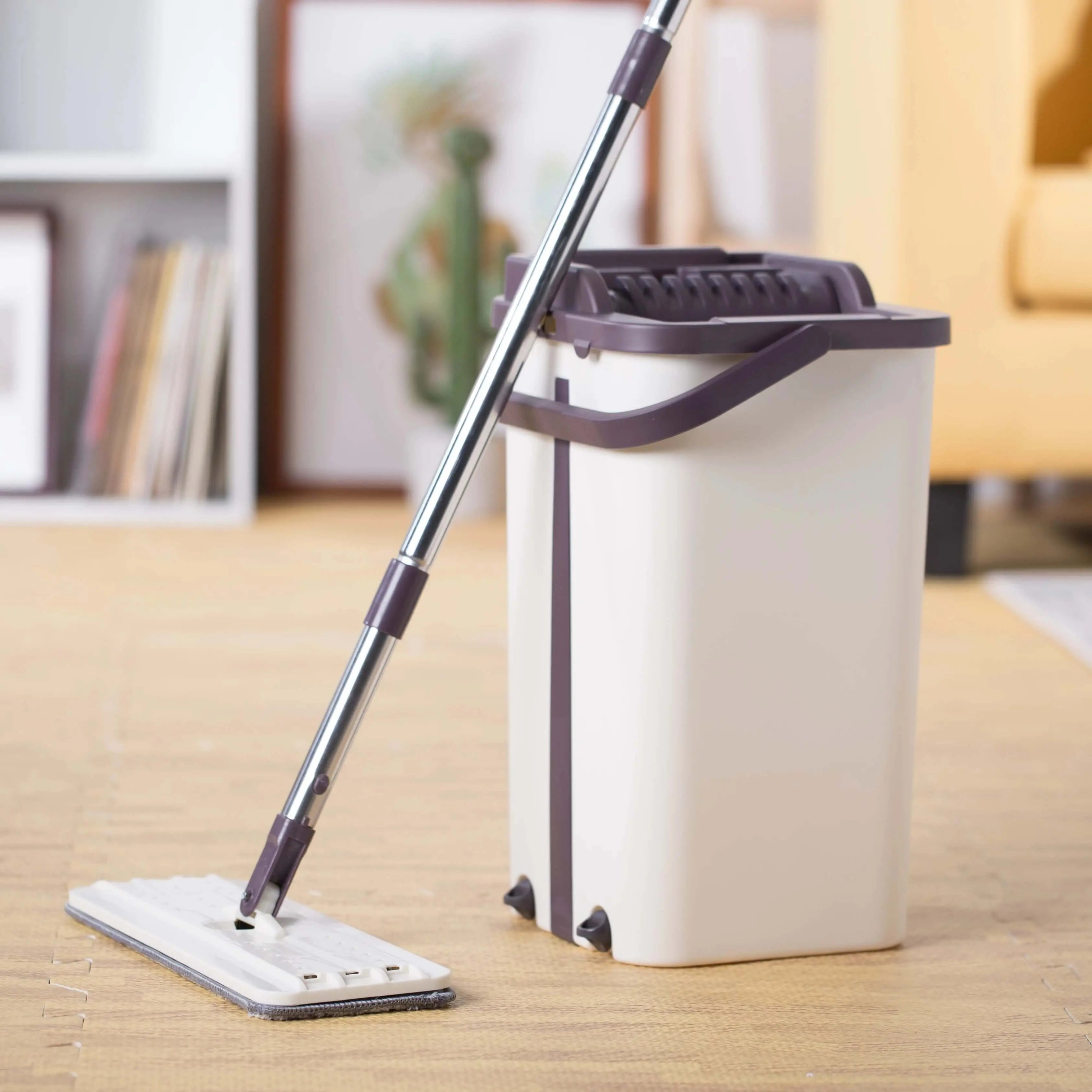 Hand free flat mop with ergonomic bucket in living room setting.