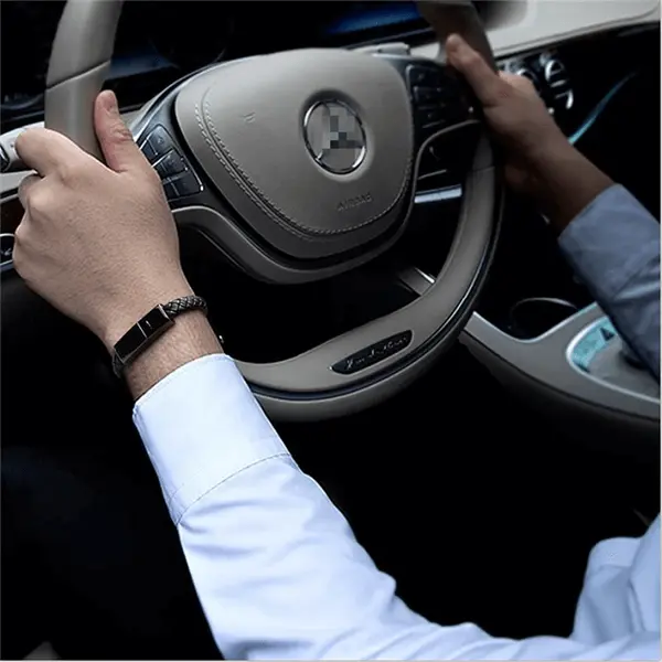 Leather Mini USB Bracelet worn while driving a car, showcasing its discreet design and functionality.