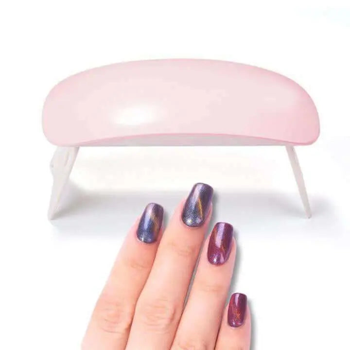 Mini Portable LED UV Nail Dryer with colorful gel manicure displayed.