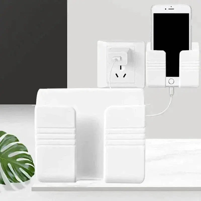 Wall-mounted mobile phone holder with a white, minimalist design next to a power outlet.