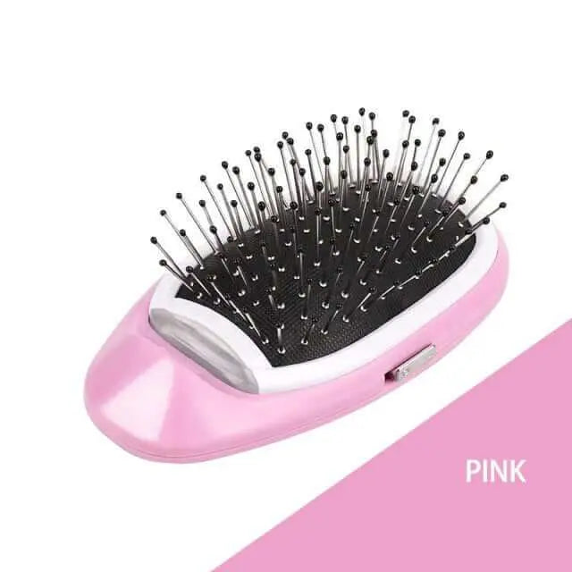 Portable electric ionic styling hairbrush in pink color with metal bristles and ergonomic design.