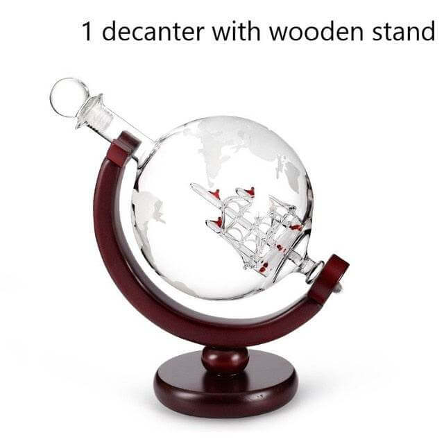 Whiskey decanter globe with sailboat motif and wooden stand.